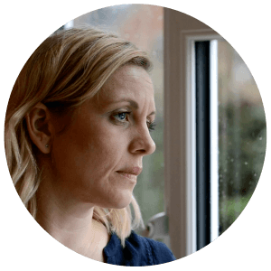 depressed woman looking out of window