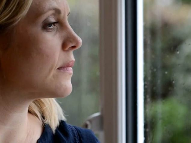 woman looking out of window